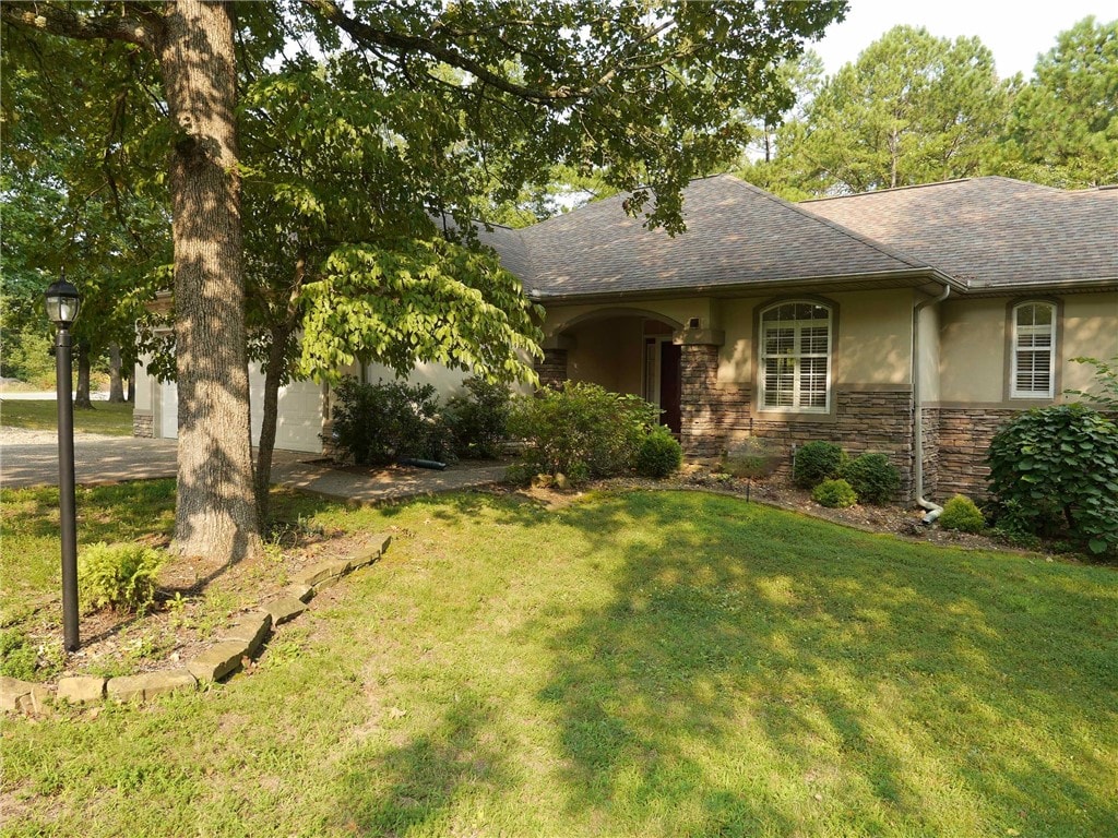 ranch-style home with a front lawn