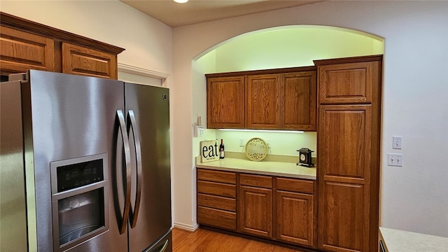 kitchen featuring stainless steel fridge and light hardwood / wood-style flooring