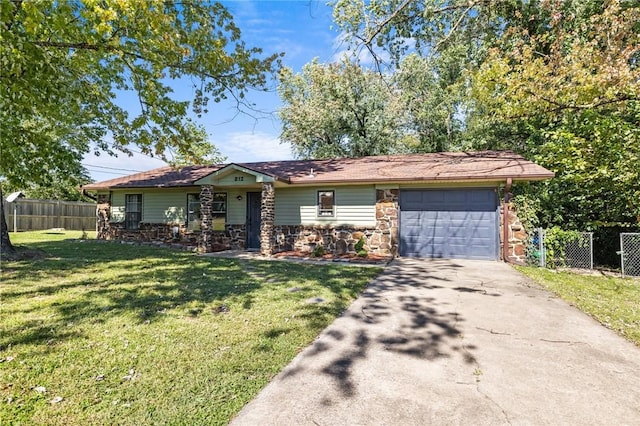 ranch-style house featuring a garage, fence, concrete driveway, stone siding, and a front yard