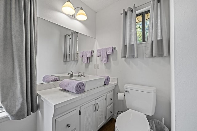 bathroom featuring vanity and toilet