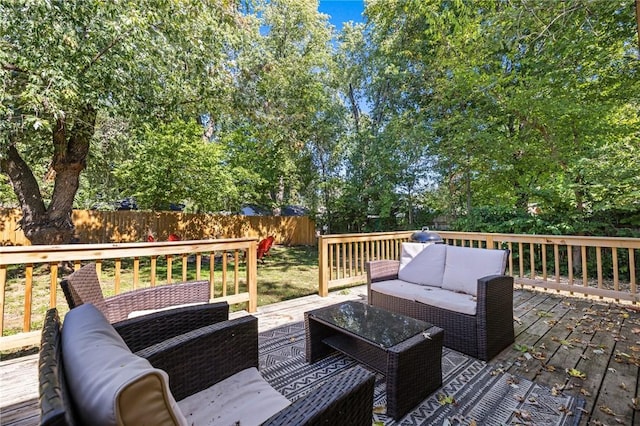 deck featuring a fenced backyard and an outdoor living space