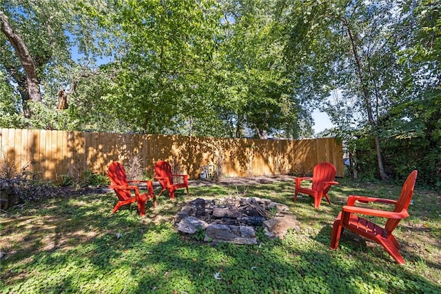 view of yard with a fire pit and fence