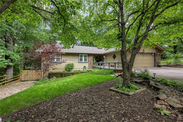 single story home featuring a garage and a front lawn