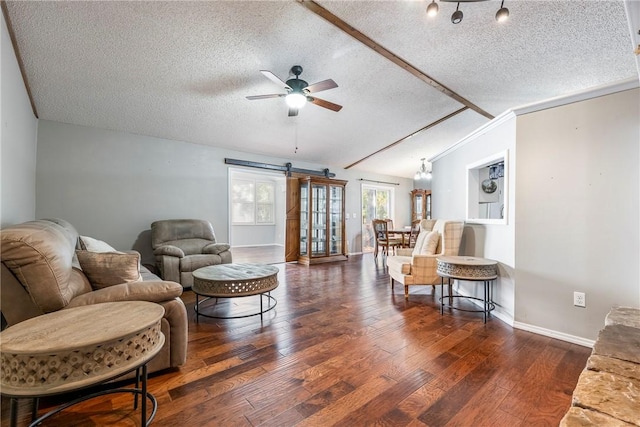 living area with ceiling fan, a textured ceiling, vaulted ceiling, and dark wood finished floors