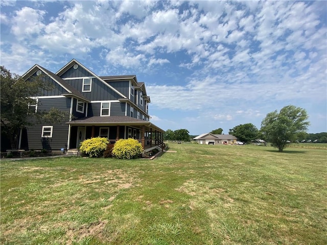 rear view of property featuring a yard