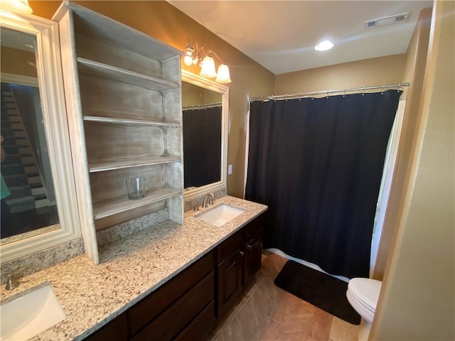 bathroom with tile patterned floors, vanity, and toilet