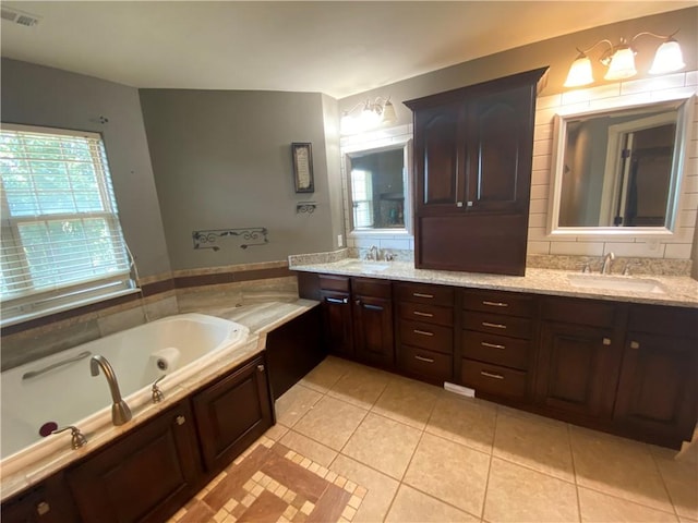 bathroom with vanity, tile patterned flooring, and a bathing tub