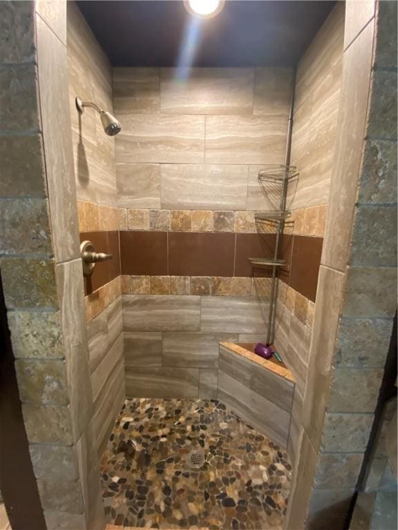 bathroom with tiled shower