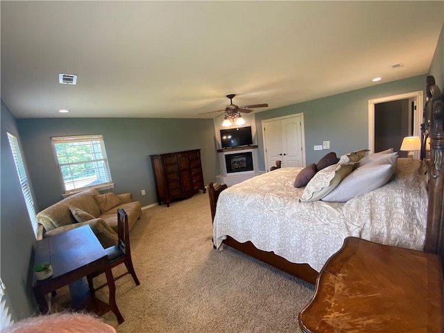 carpeted bedroom with a closet and ceiling fan