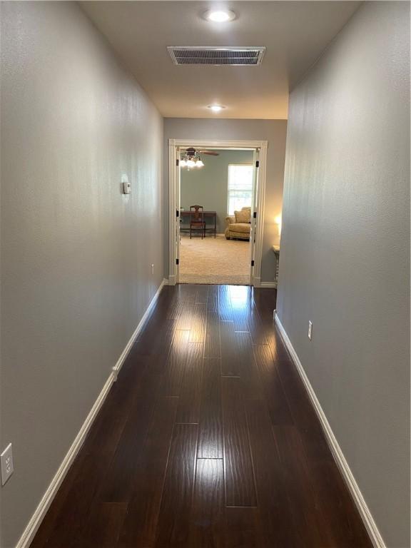 corridor with dark wood-type flooring