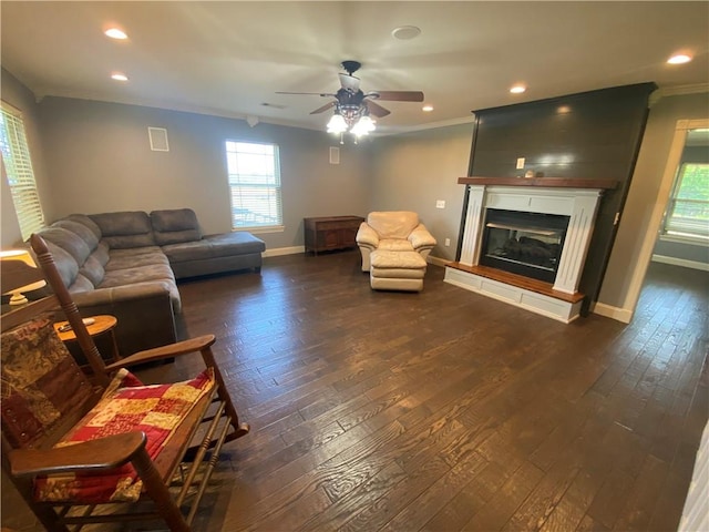 living room featuring ornamental molding, dark hardwood / wood-style floors, and ceiling fan