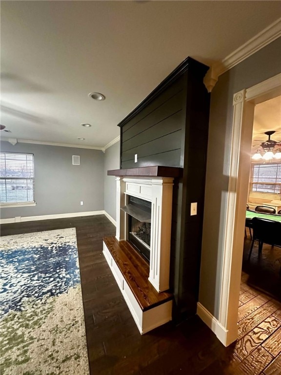 living room with crown molding and dark hardwood / wood-style flooring