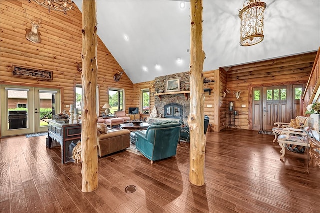 living room featuring high vaulted ceiling, dark wood-style flooring, plenty of natural light, and a fireplace