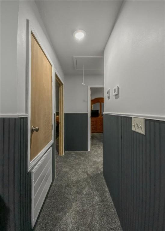 hall featuring dark colored carpet