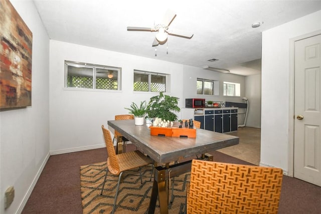 dining space with a ceiling fan, visible vents, and baseboards