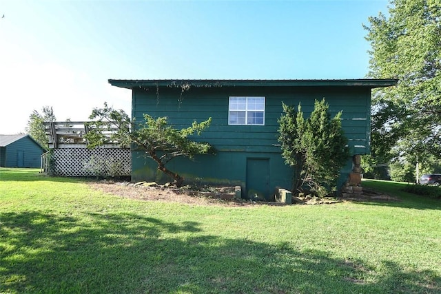 view of side of property with a lawn