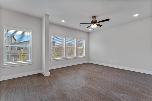 spare room with dark hardwood / wood-style floors and ceiling fan