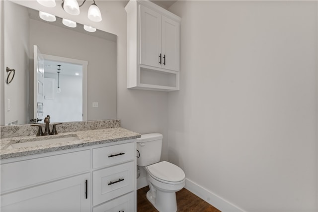 bathroom with vanity, hardwood / wood-style flooring, and toilet