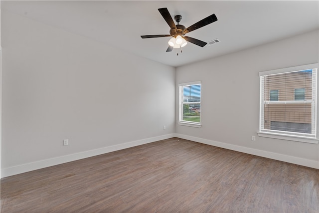 empty room with hardwood / wood-style floors and ceiling fan