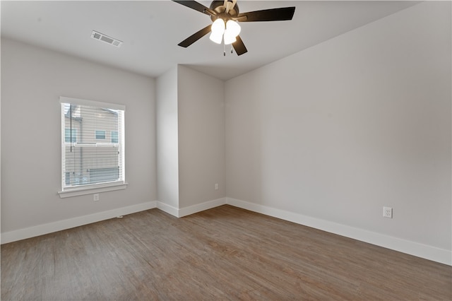 unfurnished room with hardwood / wood-style flooring and ceiling fan