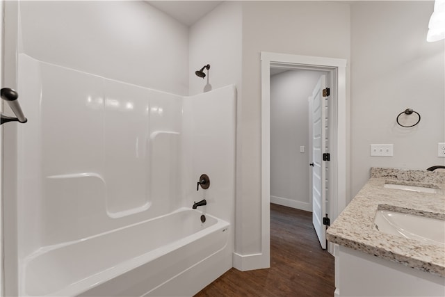 bathroom featuring vanity, shower / bathing tub combination, and hardwood / wood-style floors