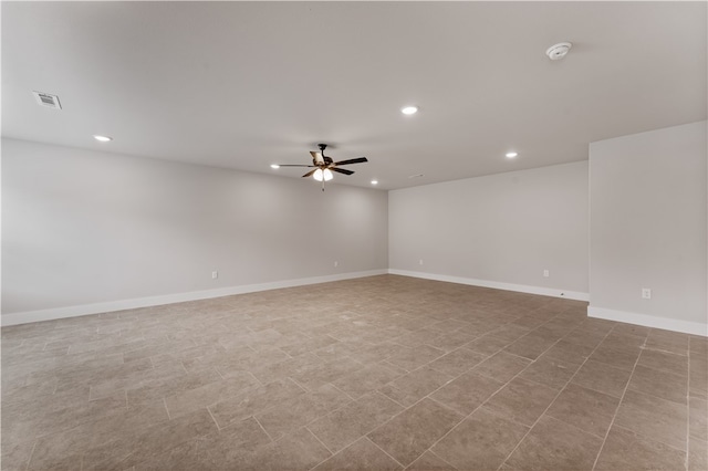 tiled spare room featuring ceiling fan