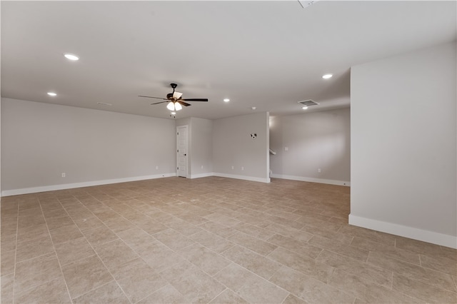 tiled spare room with ceiling fan