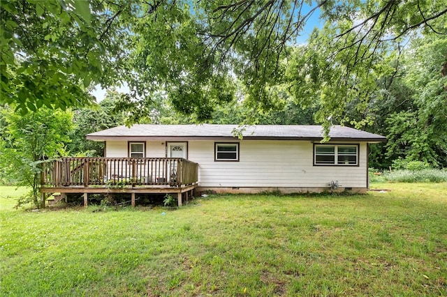 back of house featuring a yard and a deck