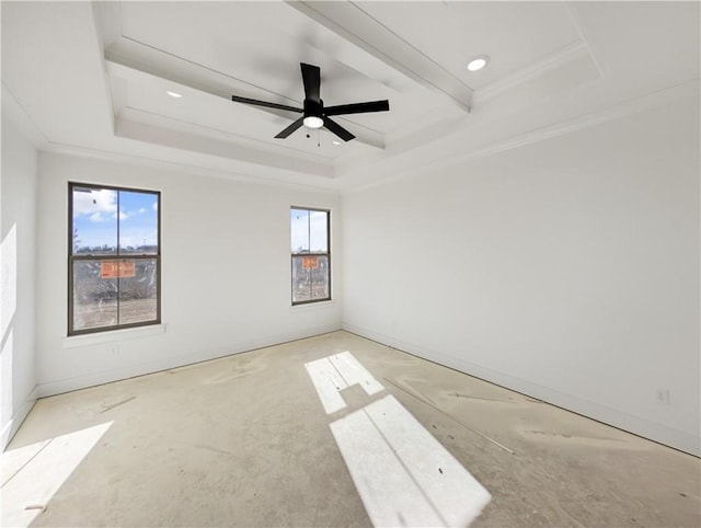 empty room featuring ceiling fan, plenty of natural light, a tray ceiling, and ornamental molding