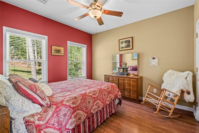 bedroom with hardwood / wood-style flooring and ceiling fan