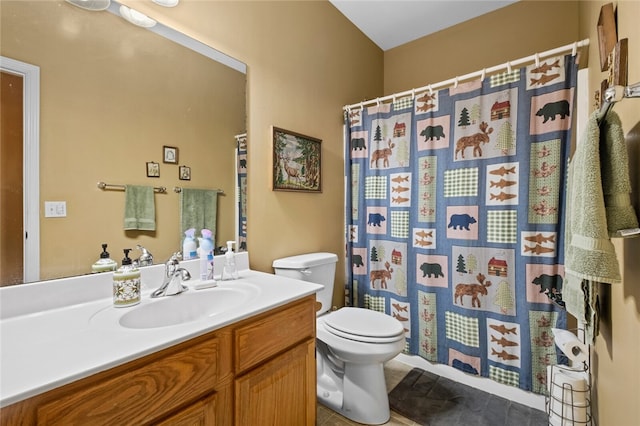 bathroom with tile flooring, vanity, and toilet