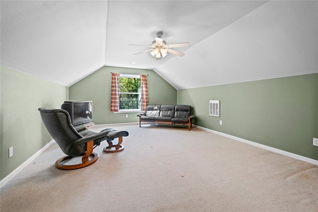 living area featuring carpet, ceiling fan, and vaulted ceiling