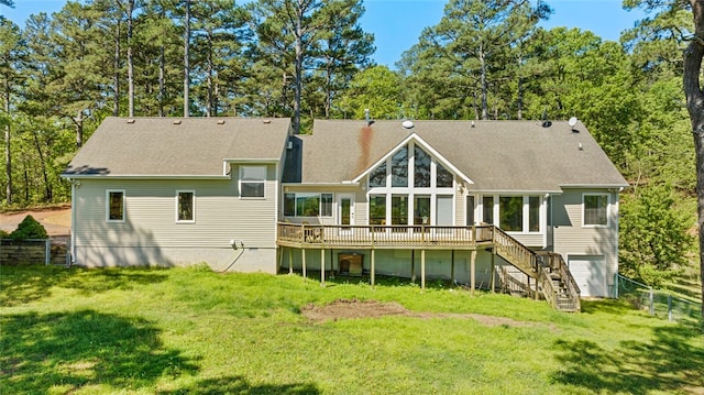 rear view of house with a wooden deck and a yard