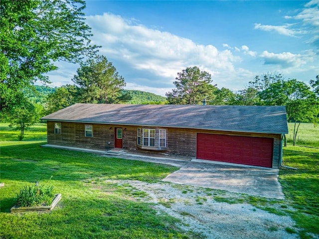 ranch-style home featuring a garage and a front lawn