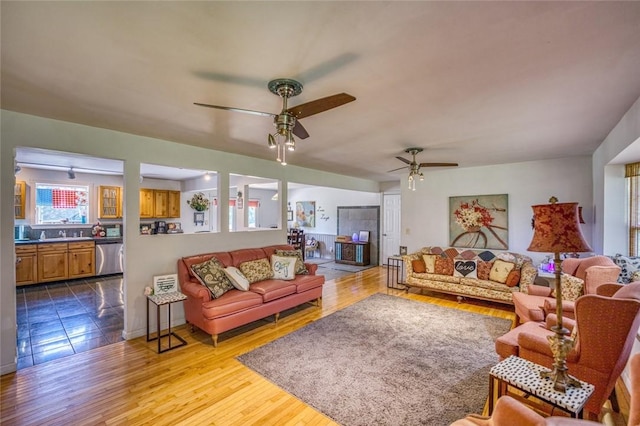 living room with ceiling fan and light wood-type flooring