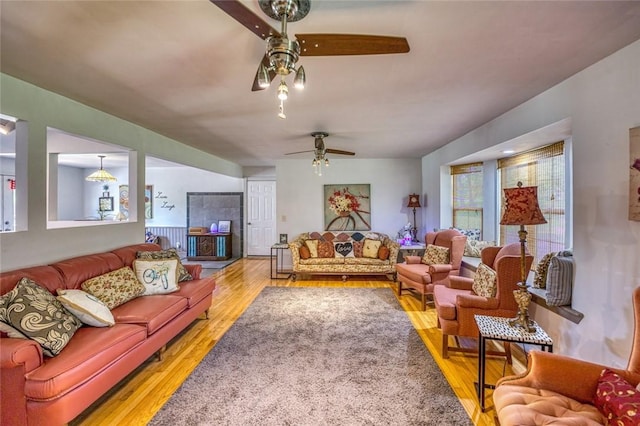 living room featuring wood-type flooring and ceiling fan