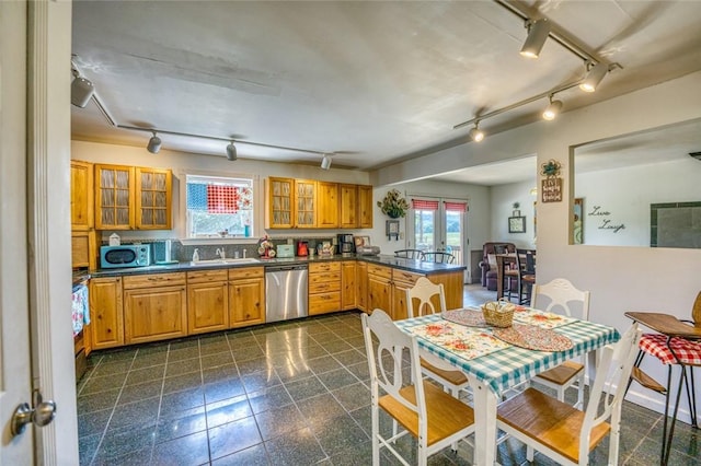 kitchen with kitchen peninsula, sink, stainless steel dishwasher, and french doors