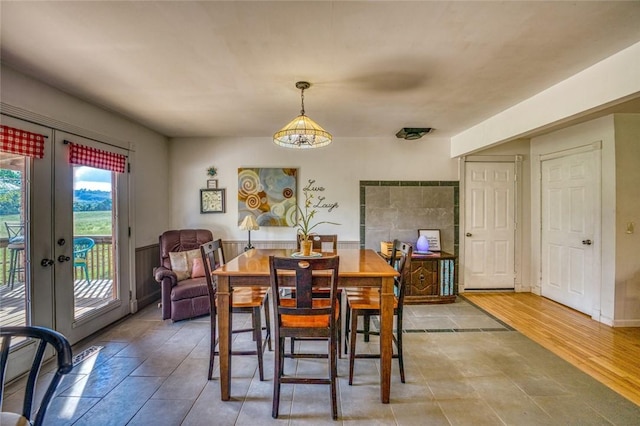 dining space featuring a chandelier, french doors, and hardwood / wood-style floors