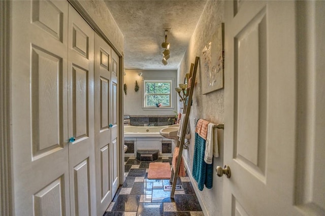 corridor with a textured ceiling