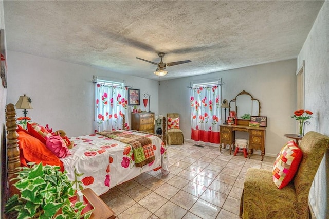 tiled bedroom featuring a textured ceiling and ceiling fan