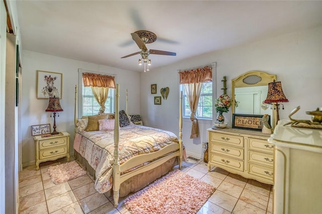 tiled bedroom featuring ceiling fan