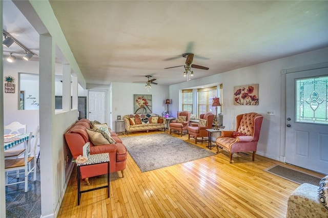 living room featuring ceiling fan and light hardwood / wood-style floors