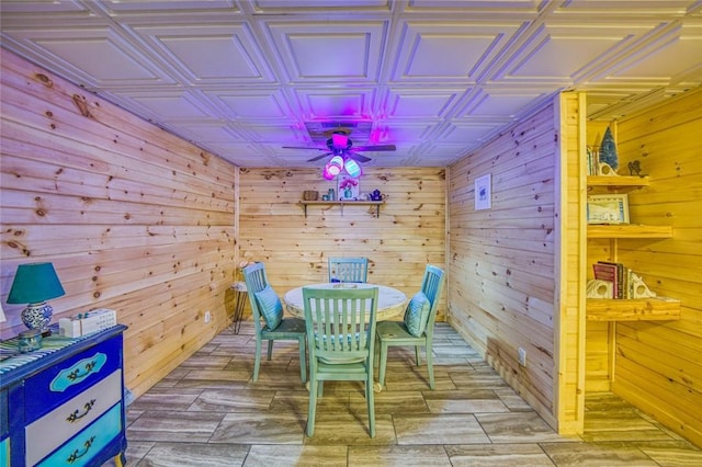 playroom featuring wooden walls and ceiling fan