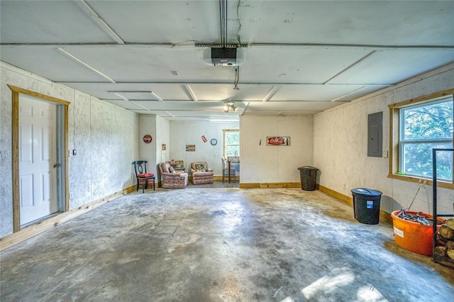 garage featuring electric panel and a garage door opener