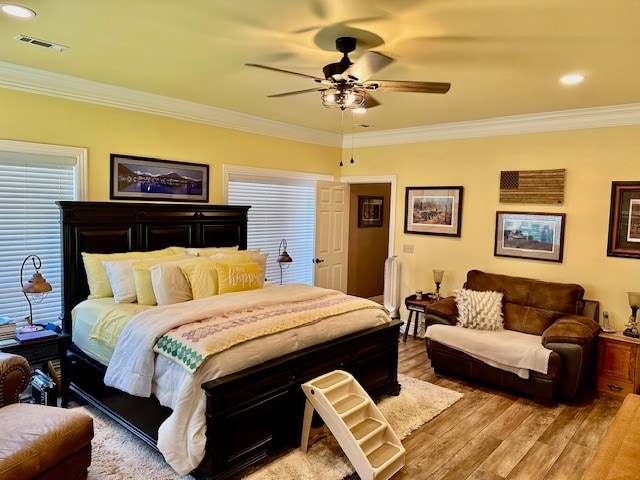 bedroom featuring crown molding, ceiling fan, and hardwood / wood-style floors