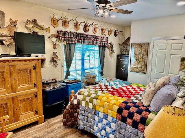 bedroom featuring ceiling fan and light hardwood / wood-style flooring