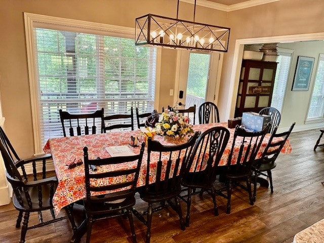 dining room featuring hardwood / wood-style floors, a chandelier, and crown molding