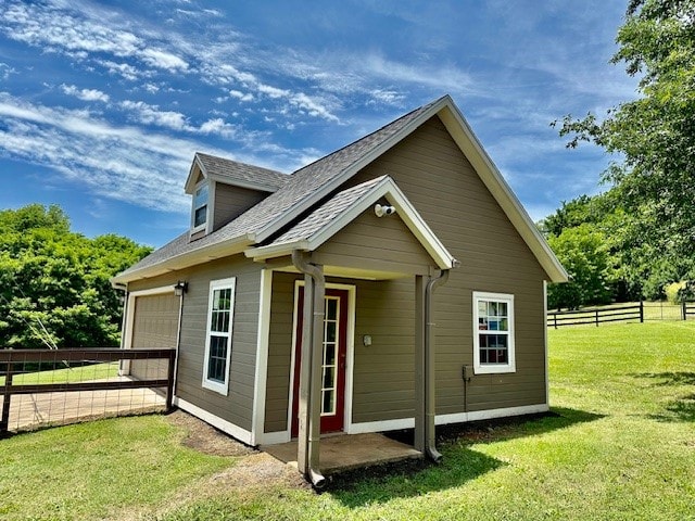 exterior space featuring a garage and a yard