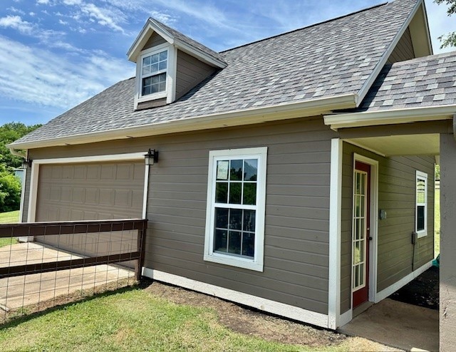 view of property exterior with a garage