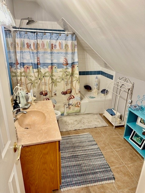 full bathroom featuring tile flooring, vaulted ceiling, toilet, and vanity